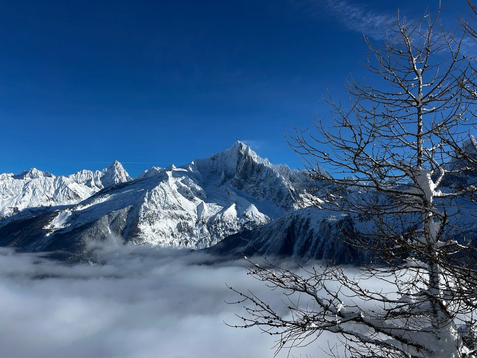 snowy mountain landscape under a clear blue sky girl powder retreat review