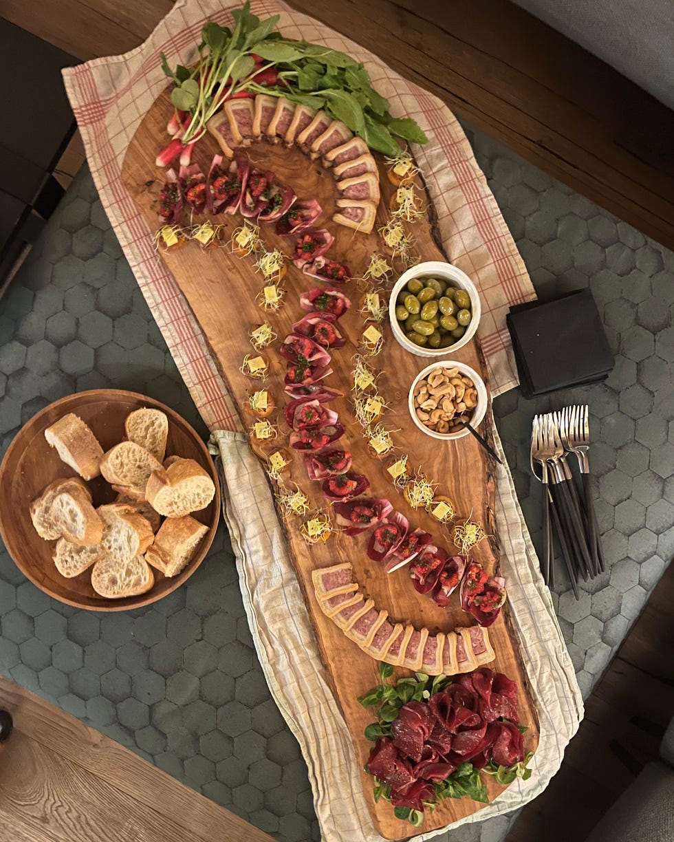 charcuterie board with various meats cheeses and accompaniments girl powder retreat review