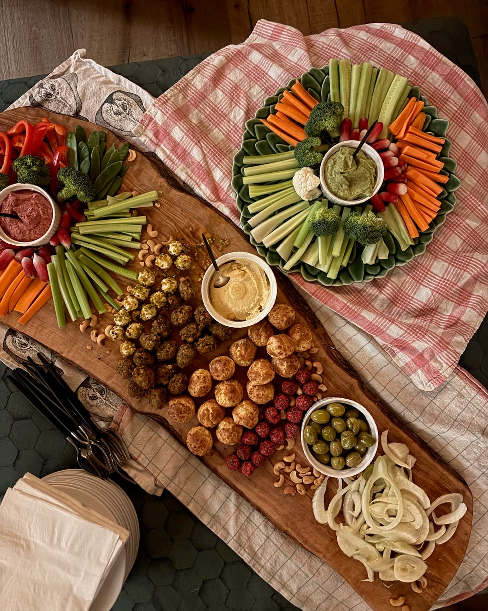 a spread of assorted vegetables dips and snacks on a wooden platter girl powder retreat review