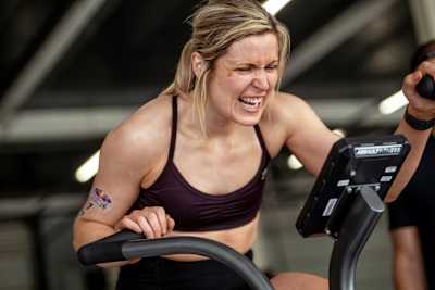 On 6th August 2025, a determined participant trains on a fitness bike at the Red Bull Pit Race during the Red Bull Hyrox coaches camp, Silverstone Circuit, UK, epitomising Red Bull energy
