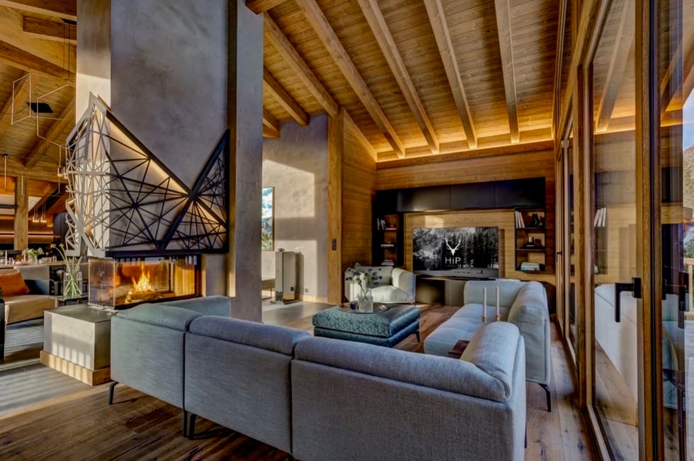 modern living room featuring a fireplace sectional sofa and a television