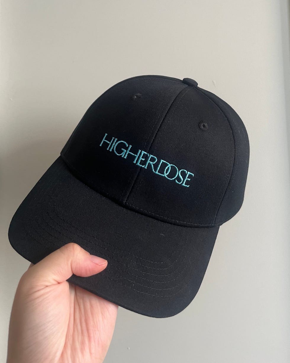 black cap with higher dose lettering