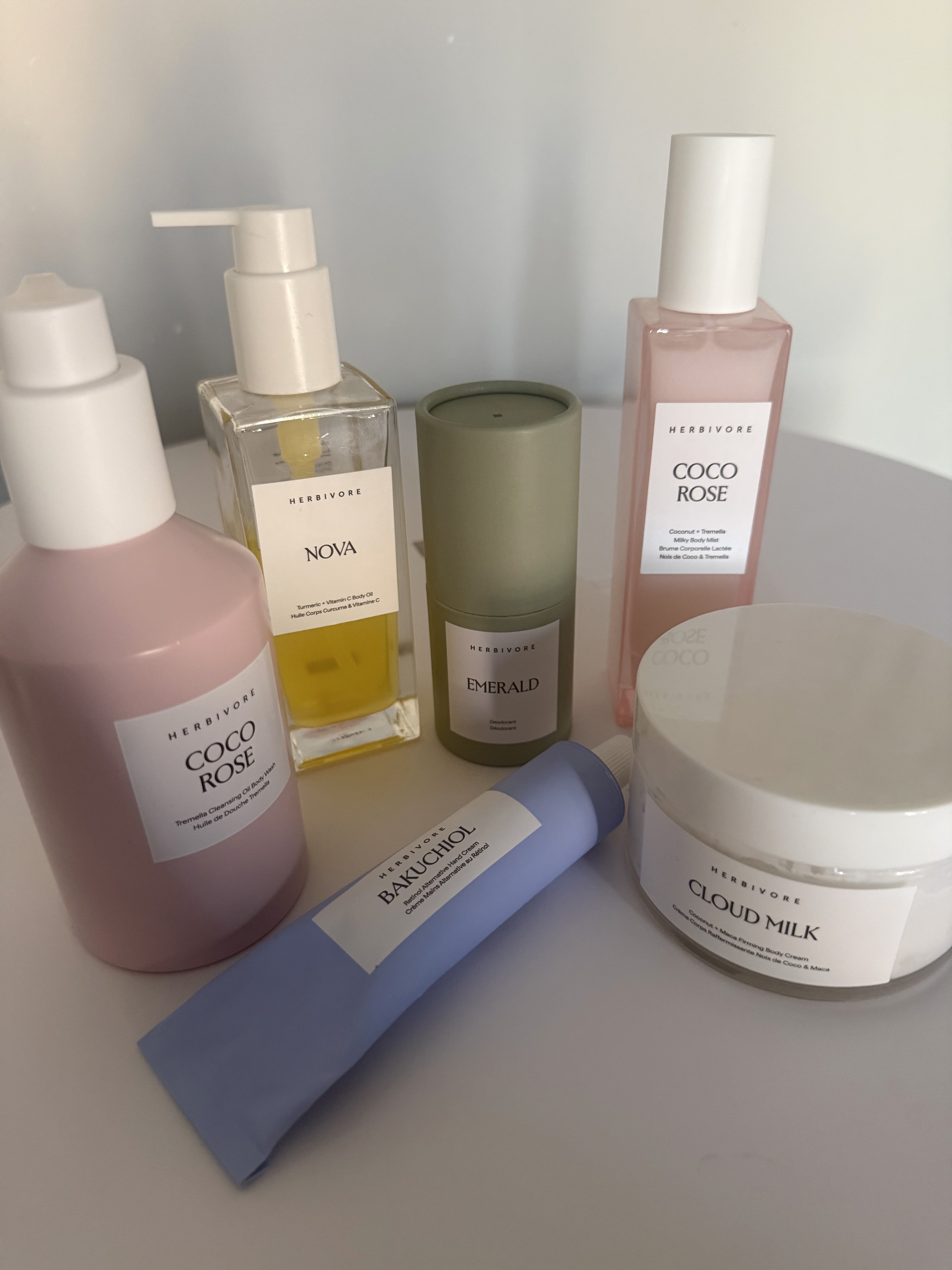 still of herbivore body care products on white table