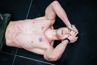 Jan Lindmaier lies exhausted on the floor after a gruelling challenge at a HYROX event in Vienna, Austria, in February 2026.