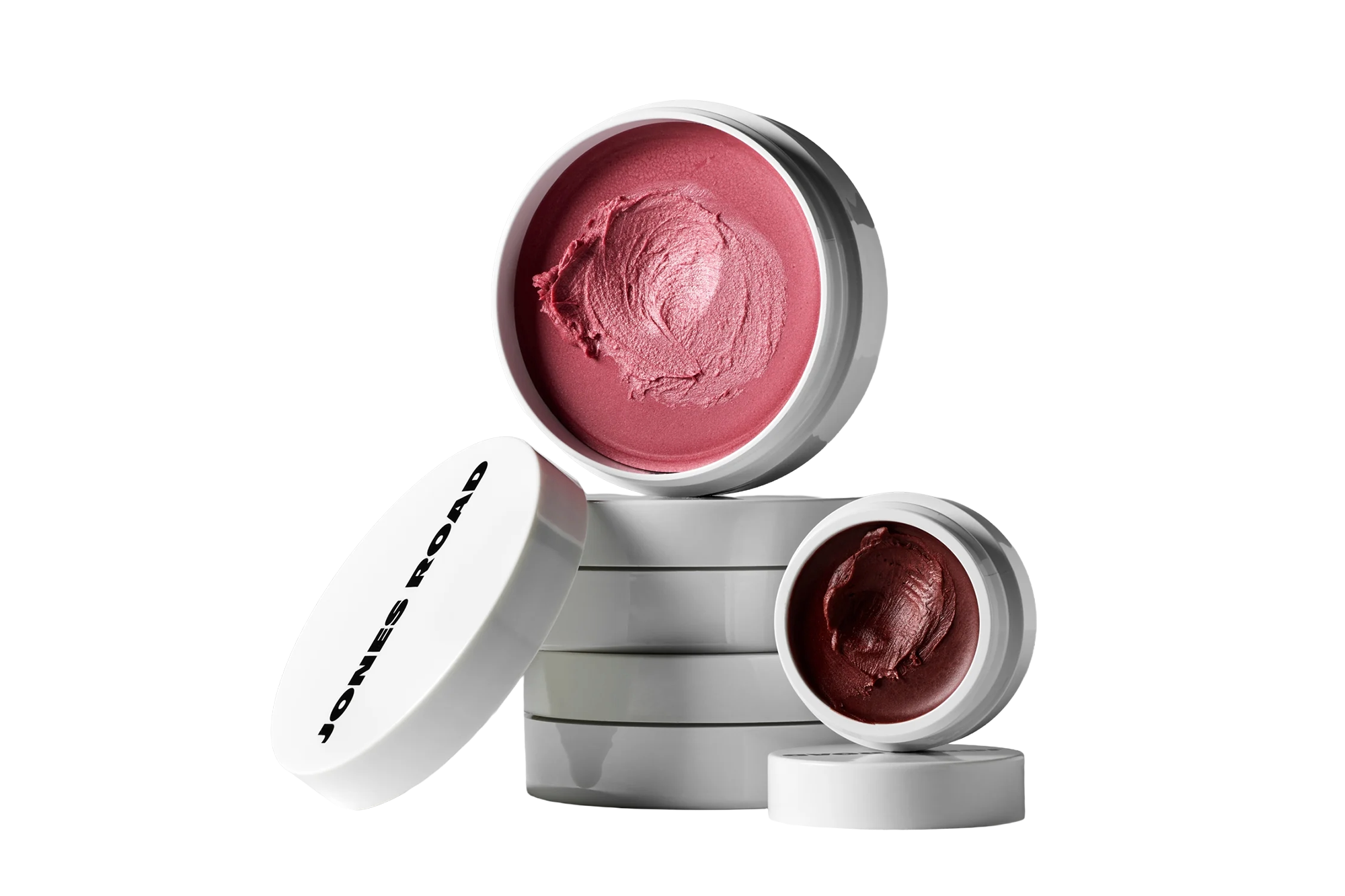 Jones Road Miracle Balm in pink and plum shades.