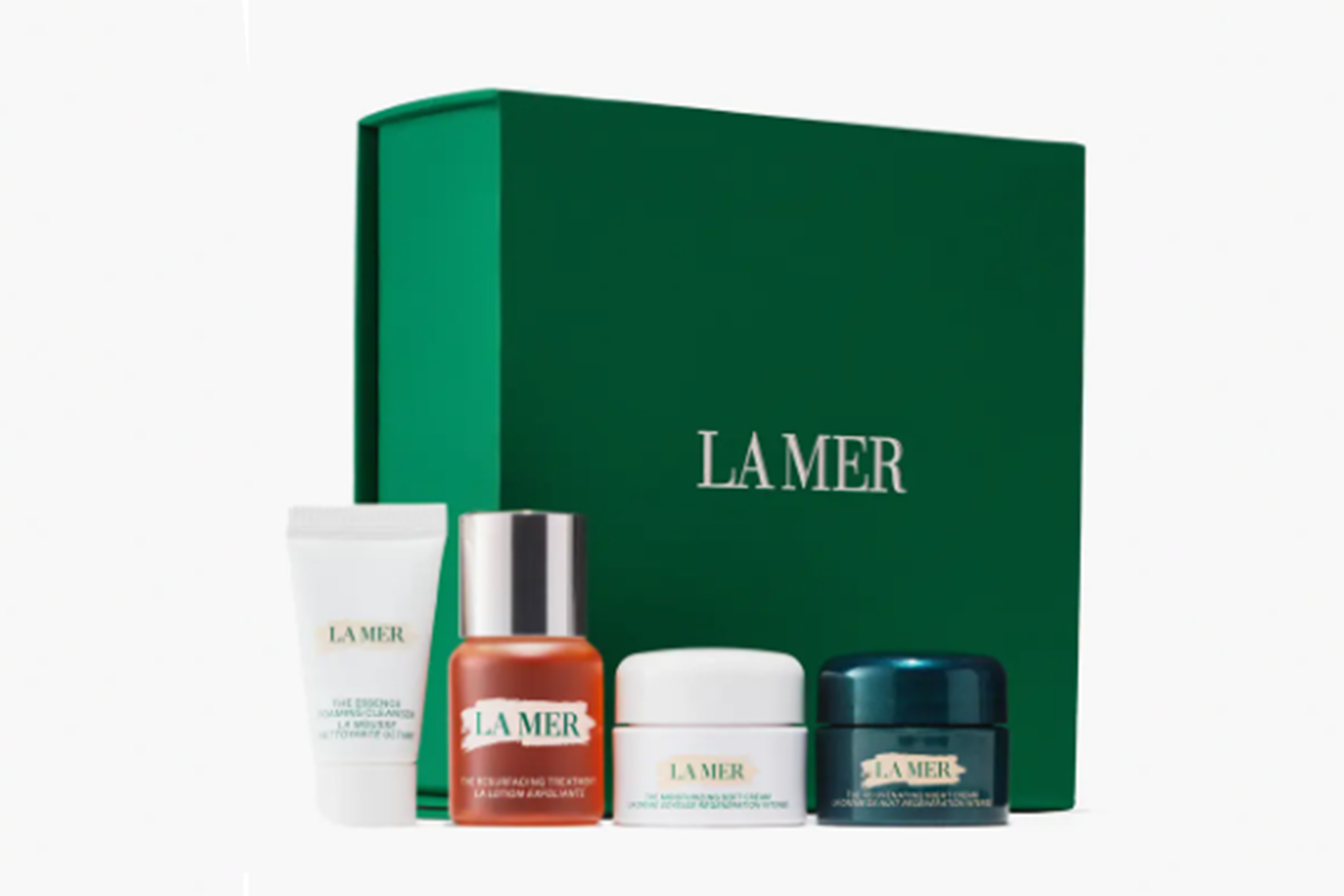 La Mer skincare products, including four mini bottles and a green box.