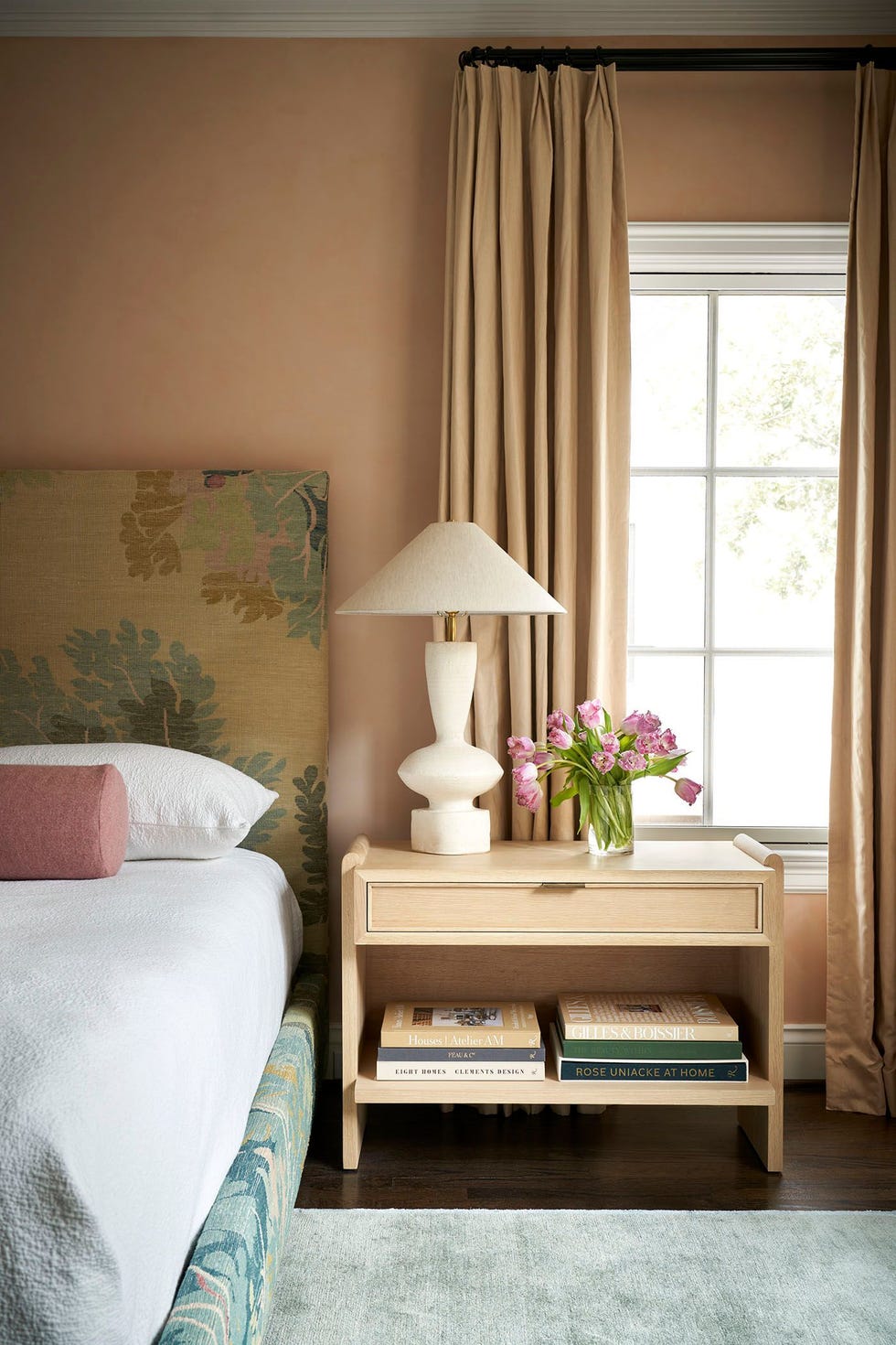 bedroom interior with a bedside table lamp and flowers