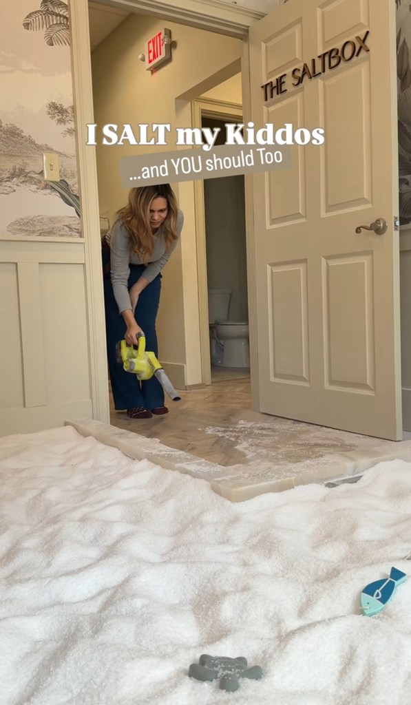 A woman uses a leaf blower in a room filled with salt with the text "I SALT my Kiddos... and YOU should Too".