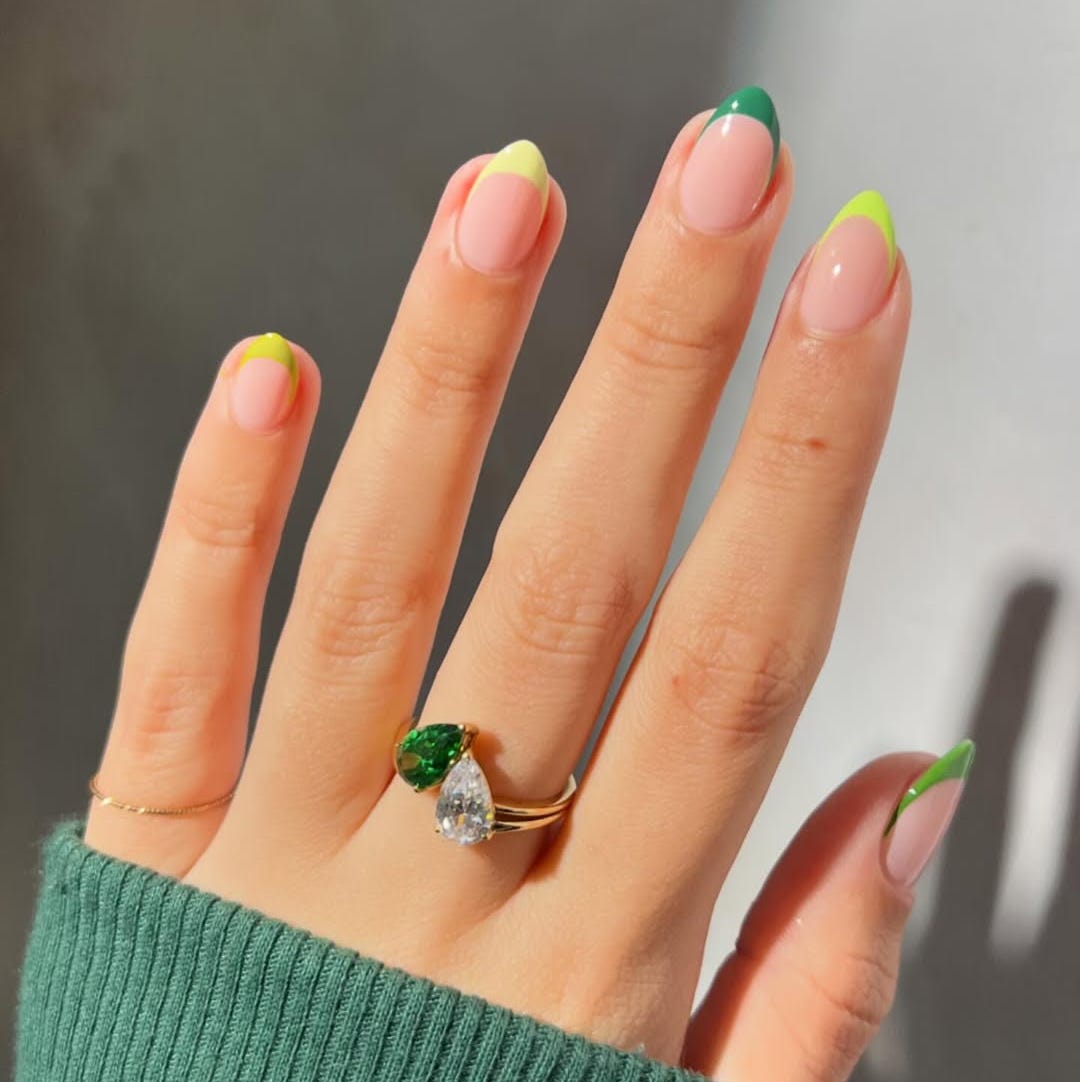 nail art with colorful tips and a ring on a hand