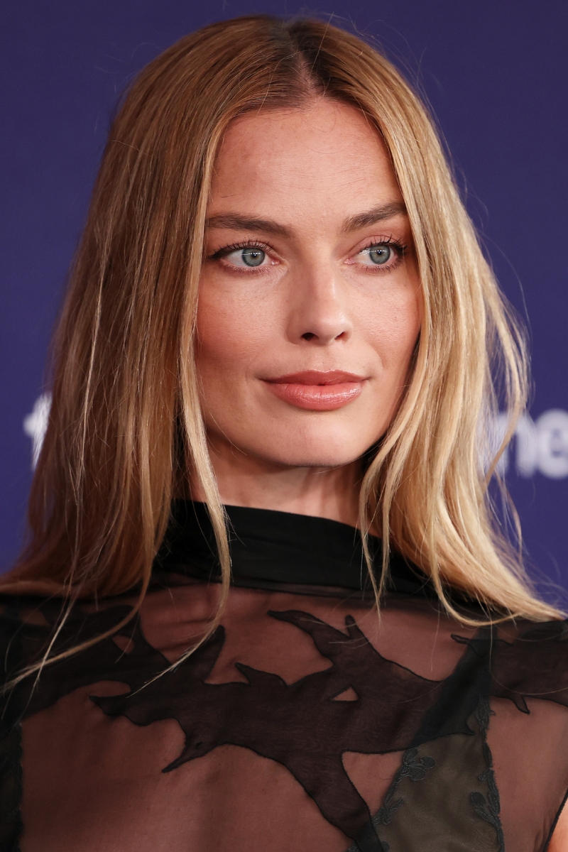 Margot Robbie is pictured with neutral, warm brown eyeshadow and wearing a black mess dress at Tropfest 2026 at Centennial Park on February 22, 2026 in Sydney, Australia.