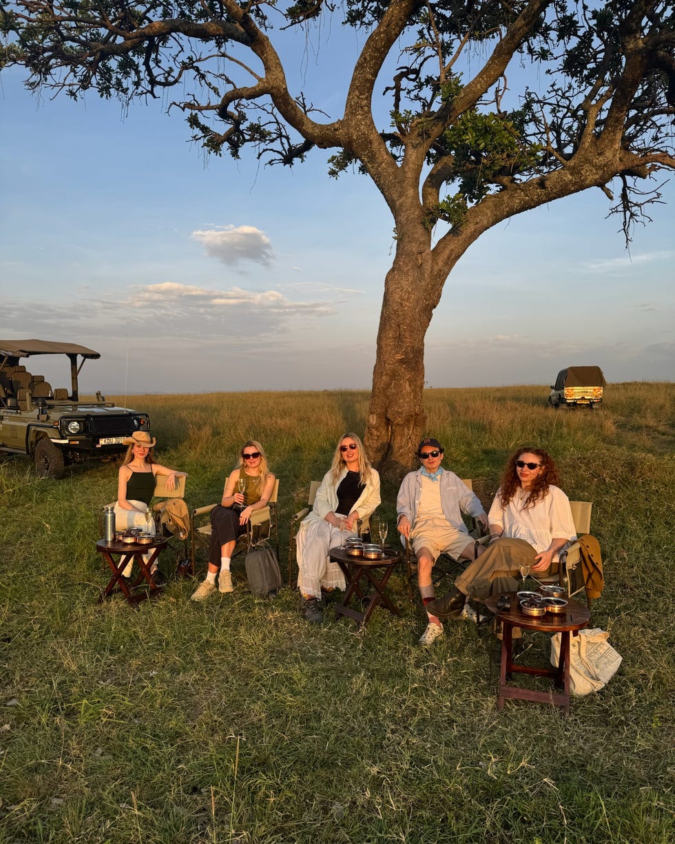 group enjoying a sunset in a safari setting paradise plains kenya