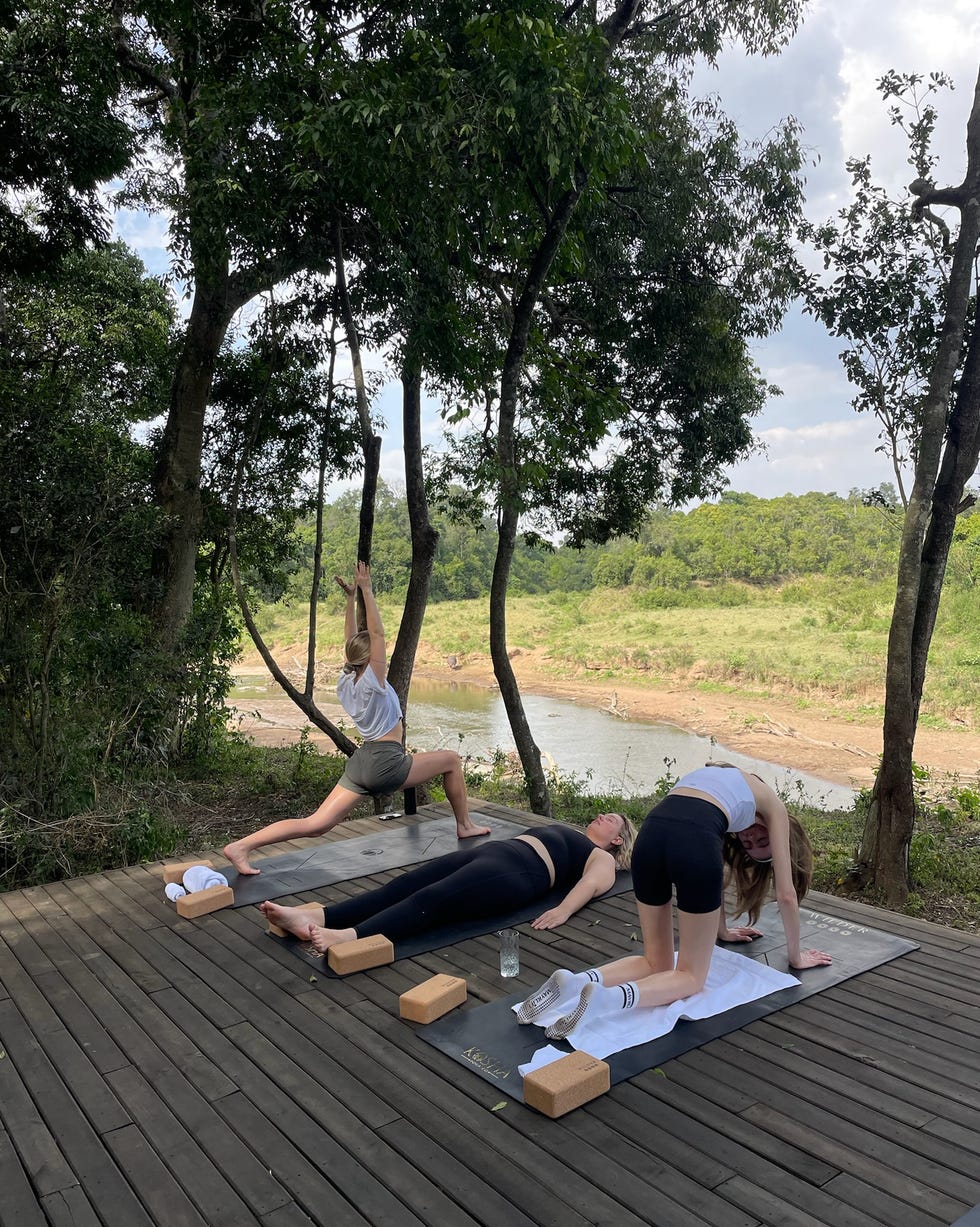 yoga session in a natural outdoor setting by the river paradise plains kenya