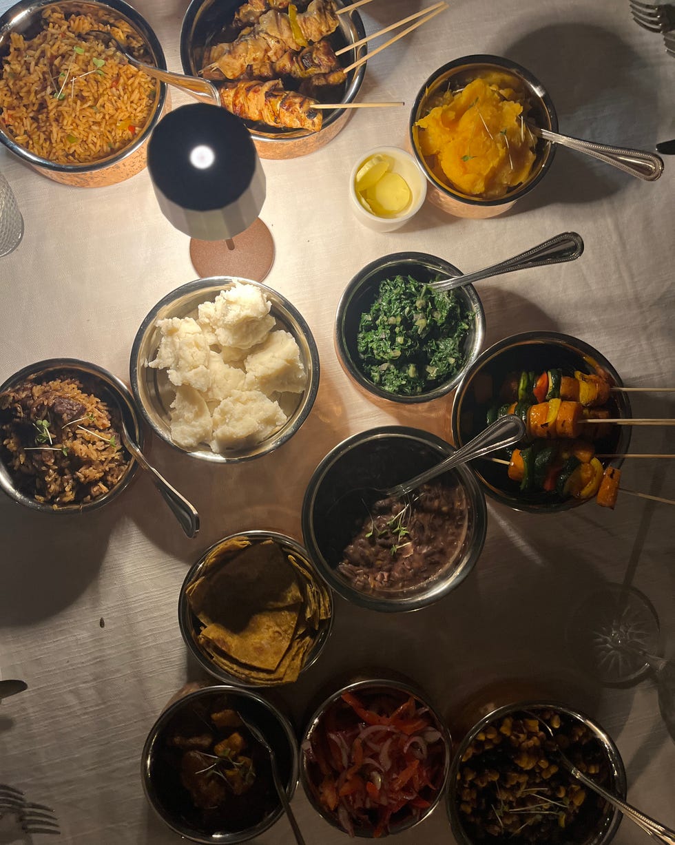 a variety of dishes served on a table sharing a traditional meal paradise plains kenya