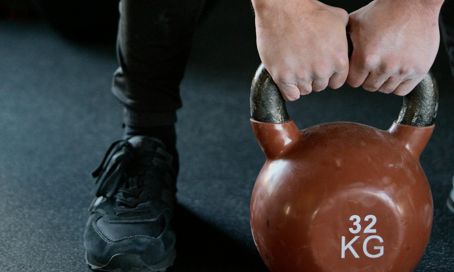 man kettlebell training weightlifting in the gym