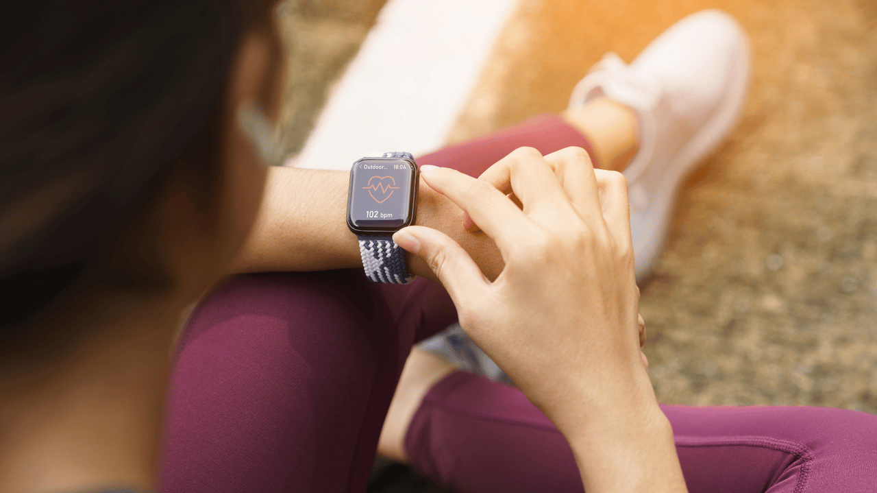 Runner checks heart monitor watch Runner checks heart monitor watch