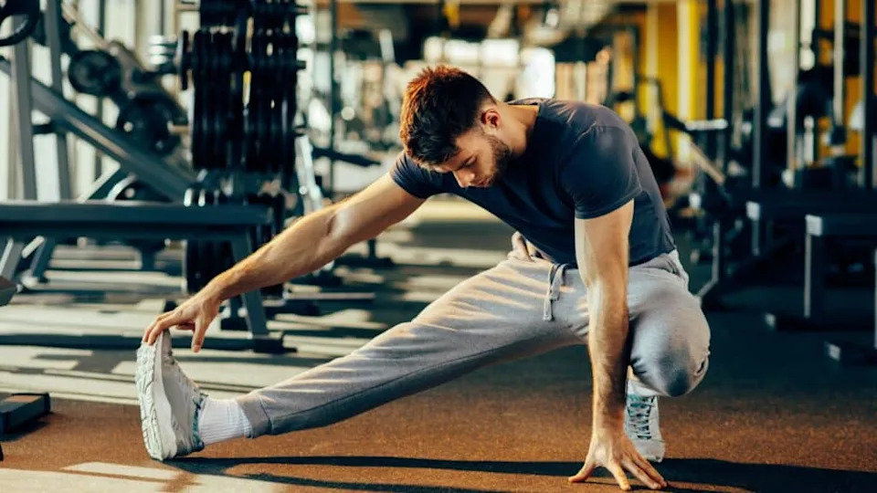 man stretching at the gym