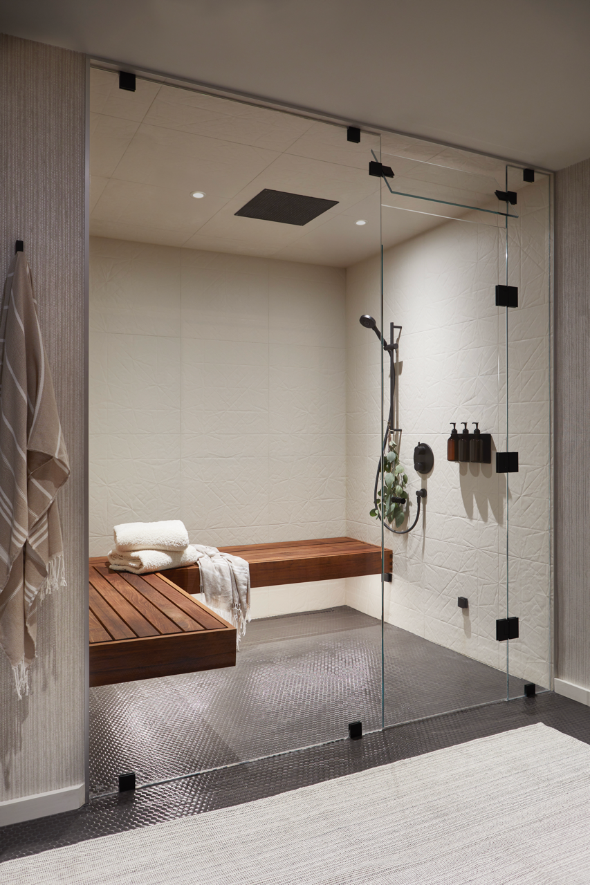 steam shower room with wooden bench and glass enclosure