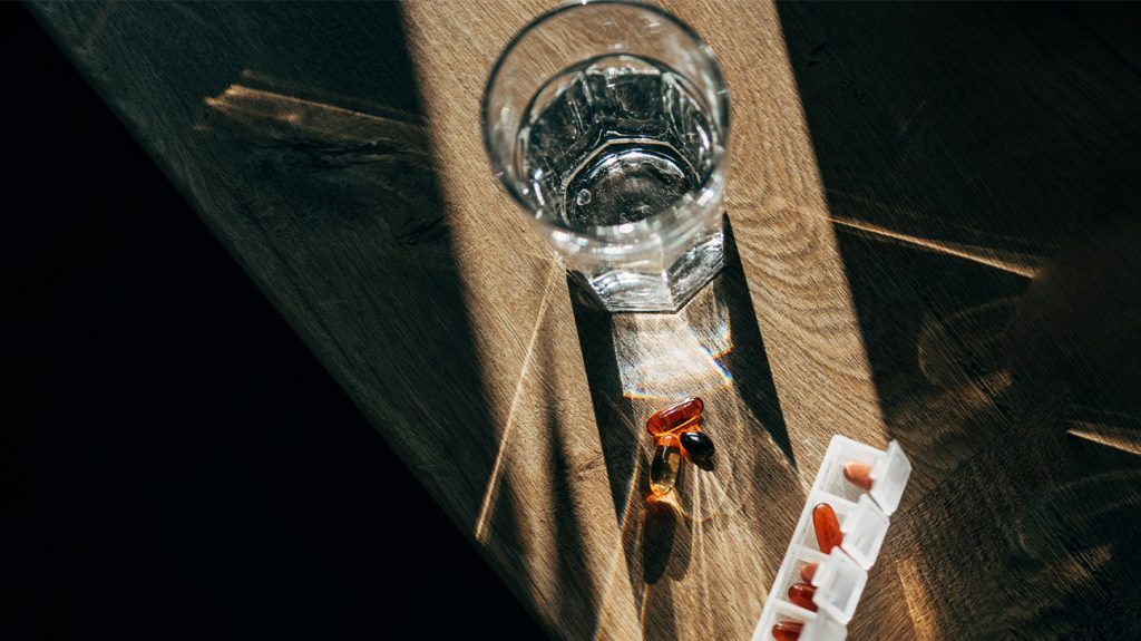 glass of water and pillbox