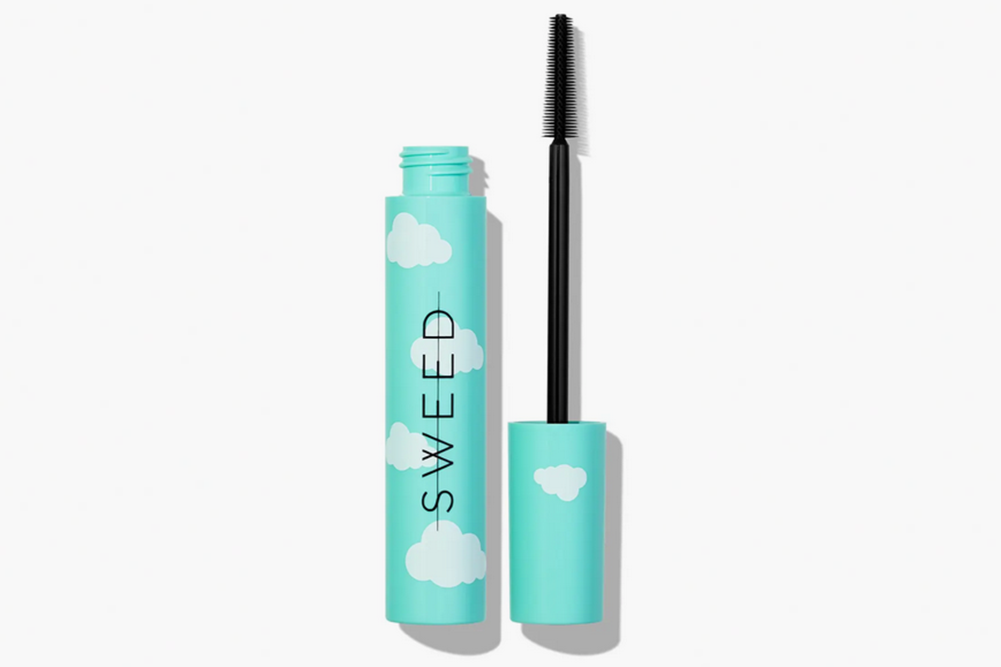 Sweed mascara in a light blue tube with white clouds, with the wand next to it.
