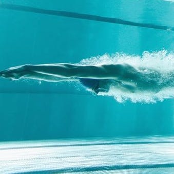Swimmer underwater after the jump