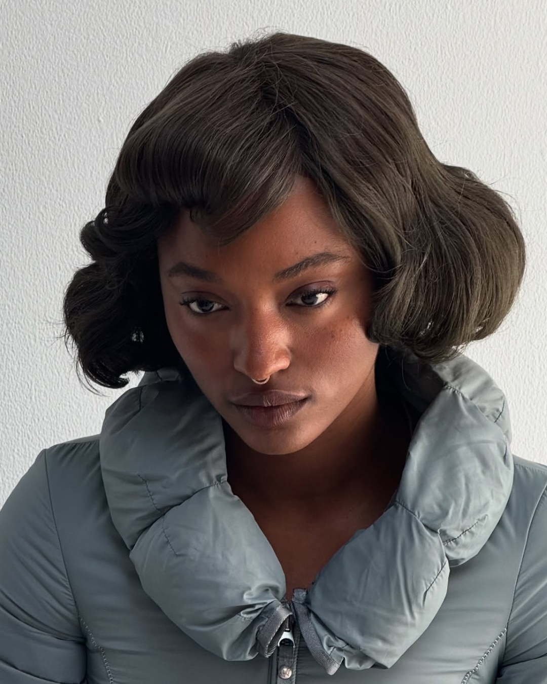 Gabrielle Joseph with matte, bronzed makeup and a retro bob