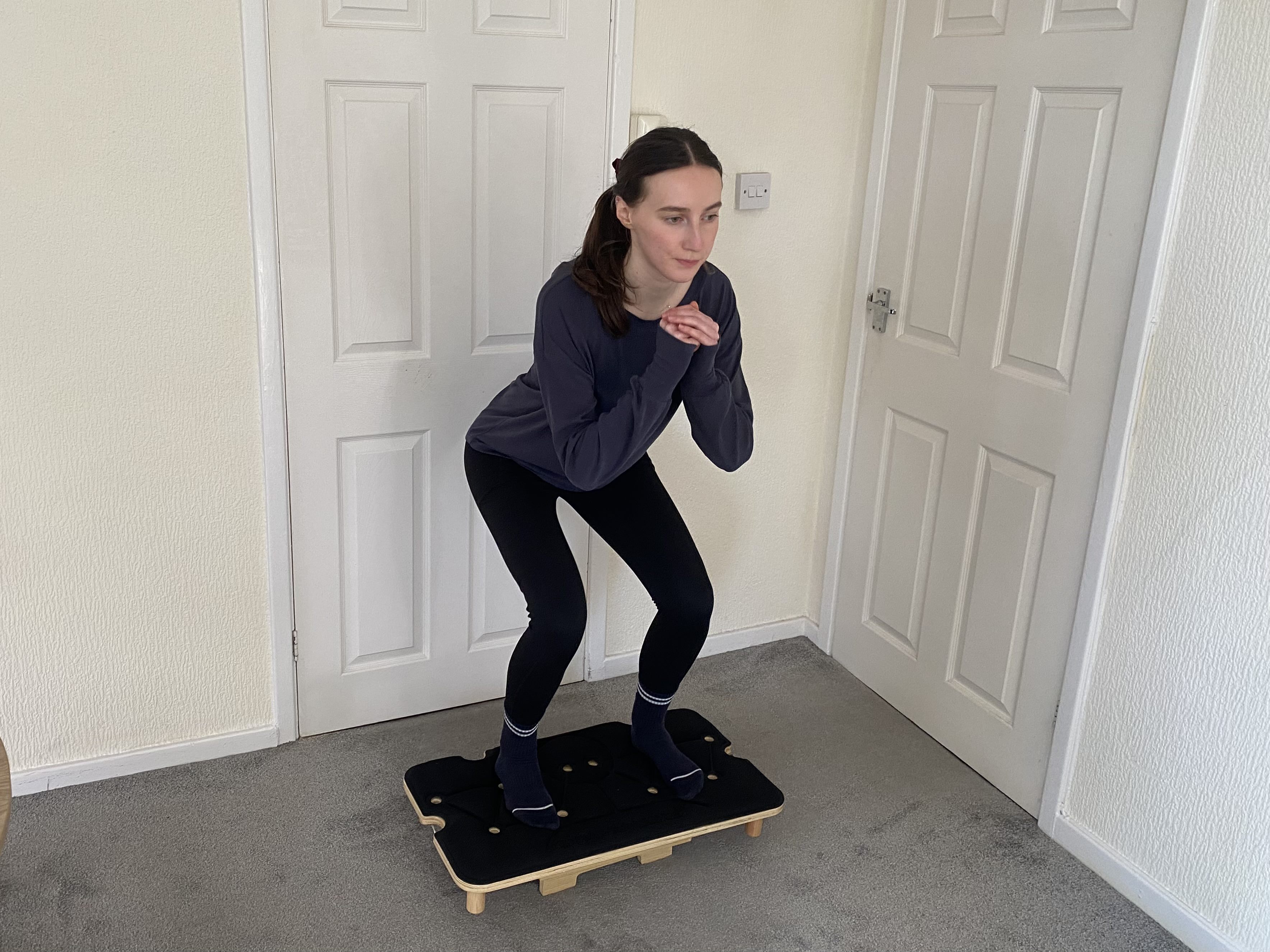 woman uses reformer pilates machine