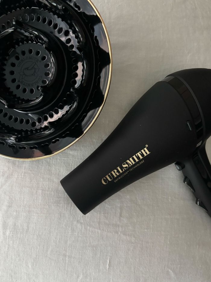 The Curlsmith diffuser on a white linen background
