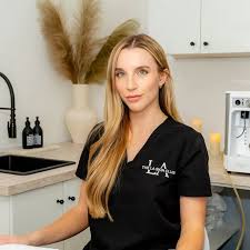 a woman with blonde hair in black scrubs