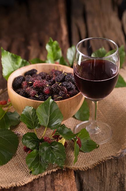 Glass of wine with bowl of berries