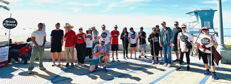 Members of Blind Fitness gather for a photo near the beach during a Walk & Run event. (Courtesy photo)