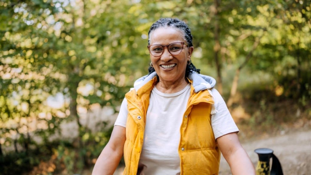 A woman walking outdoors to boost her vitamin D levels