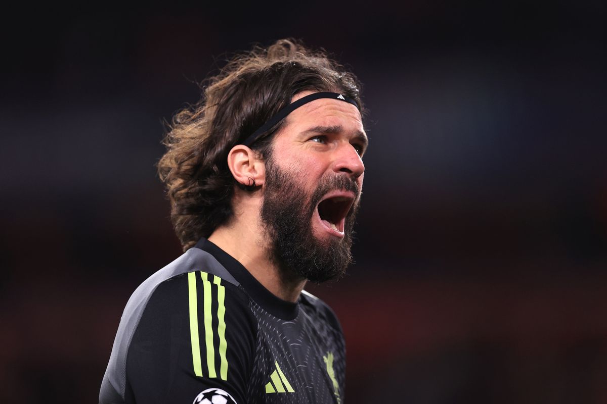 Alisson celebrates during a Liverpool game