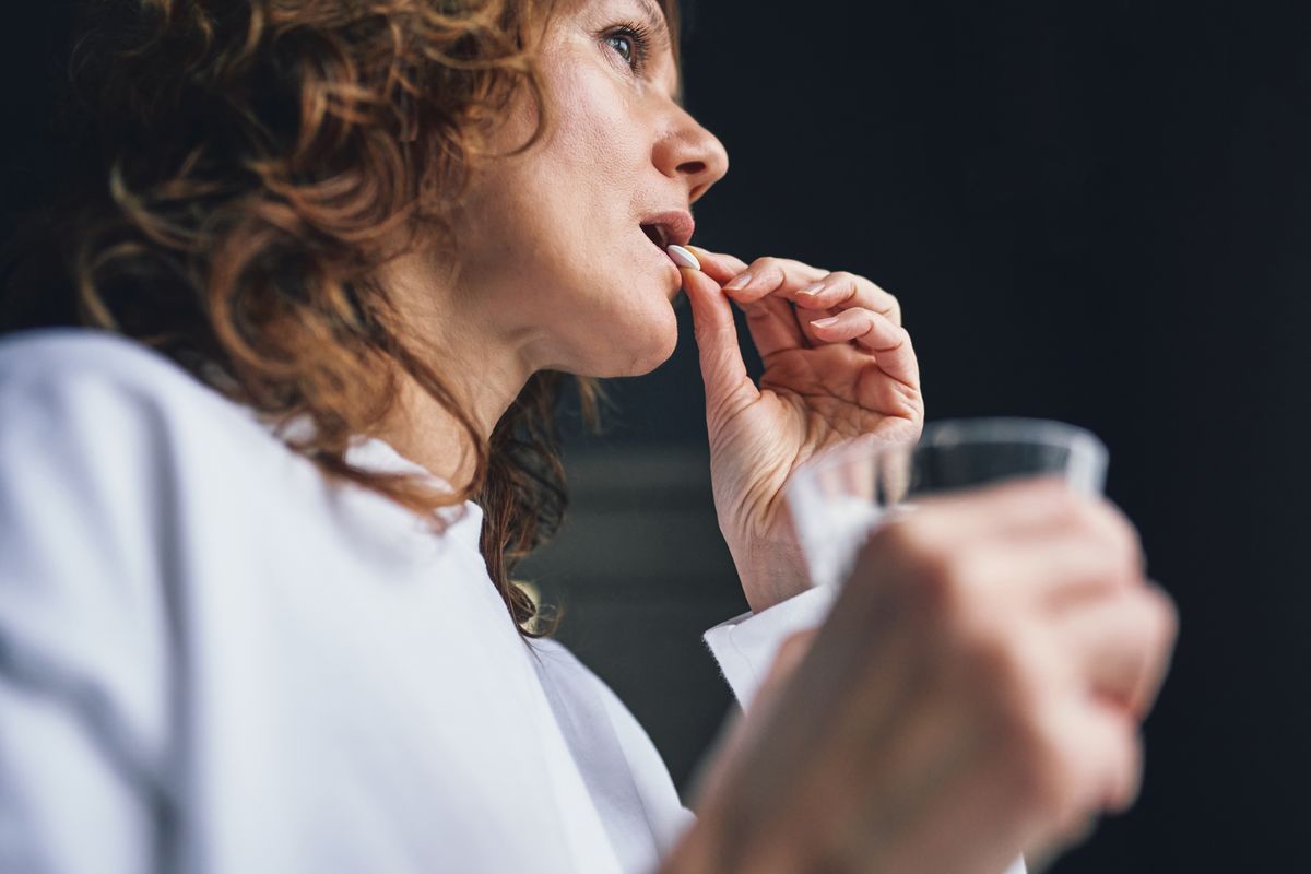 Woman taking medication for health and wellness