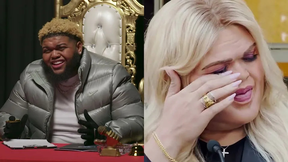 Comedian Druski in a silver jacket sits on a gold throne, smiling. Druski in whiteface, with blonde hair, wipes tears, wearing rings and makeup.