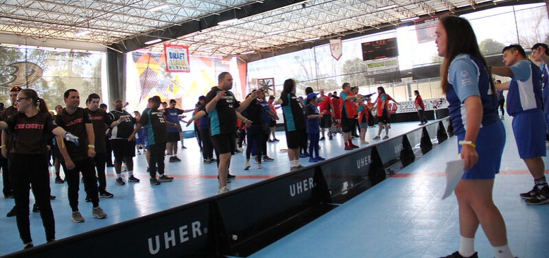 A woman leads a stretching activity before a sport event.