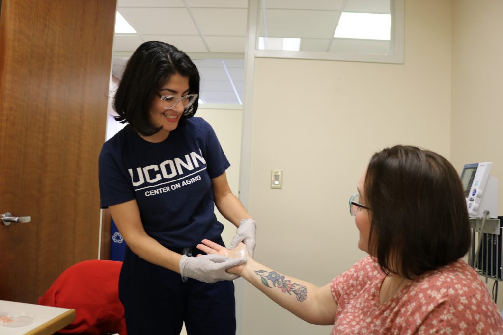 New skin patch in clinical studies in action being placed by the UConn Center on Aging study coordinator Alba Santiago at the UConn Center on Aging.