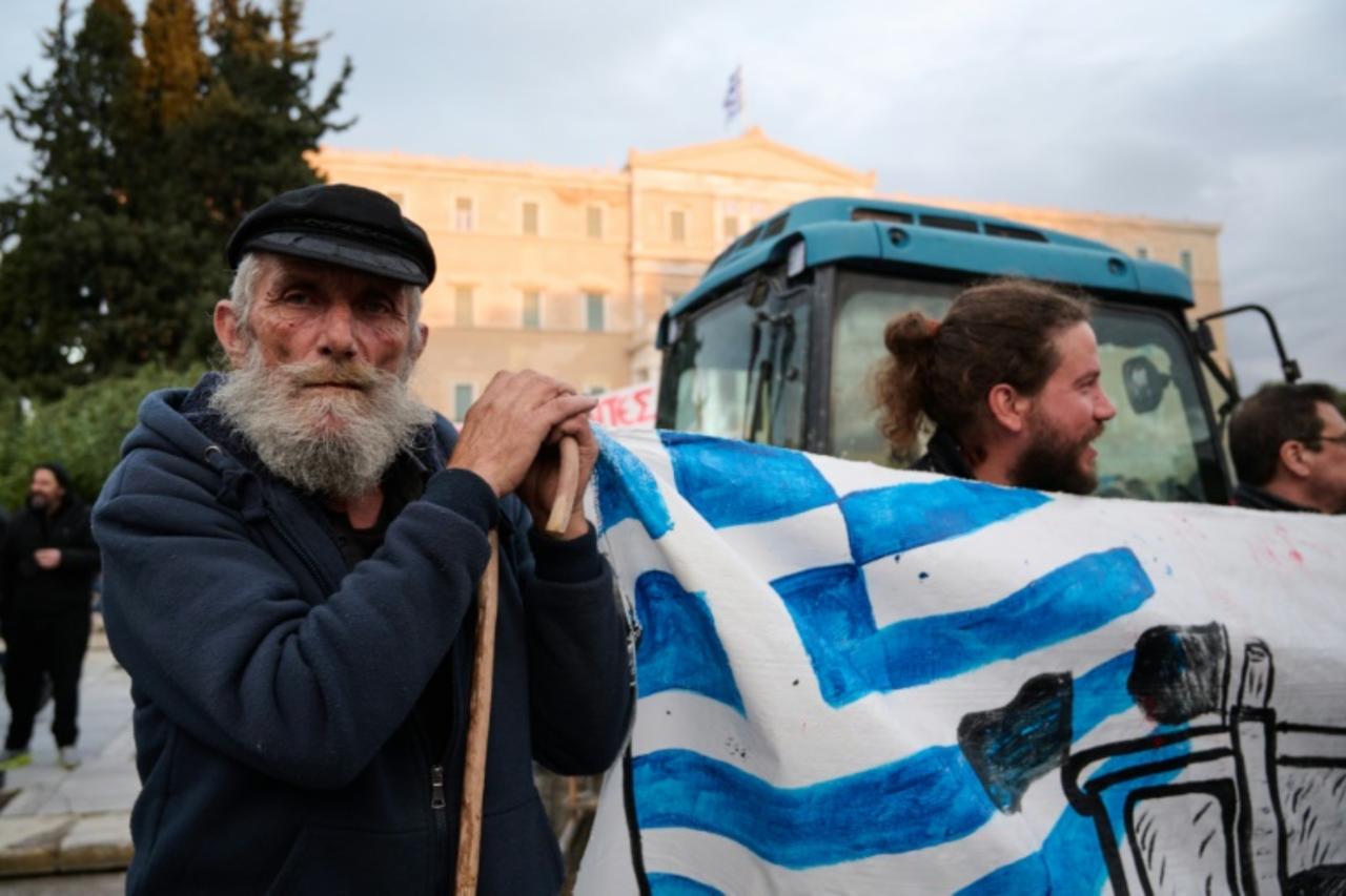 A Greek farmer takes part in a protest over long delays in subsidy payments, low prices, rising energy costs and worsening climate conditions, outside the parliament in Athens on February 13, 2026. (AFP Photo)