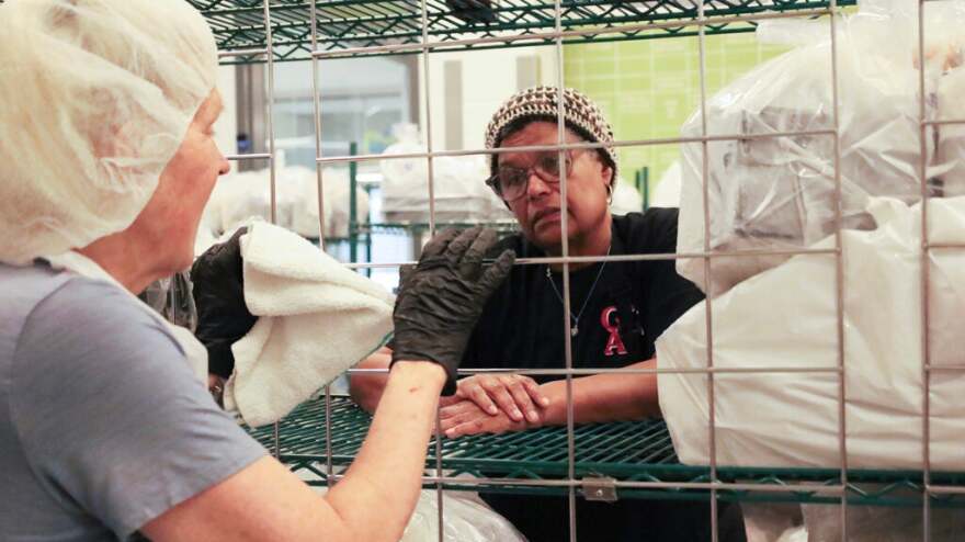 Two women have a conversation.