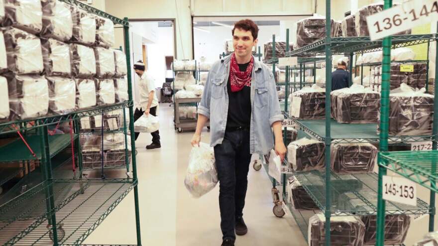 A man carries a grocery bag.