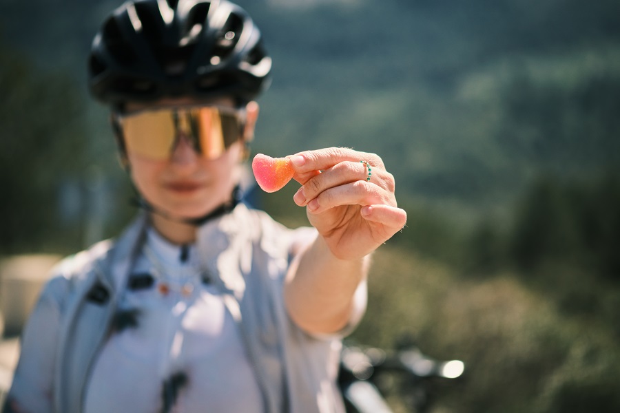 Female cyclist eating gummy supplements
