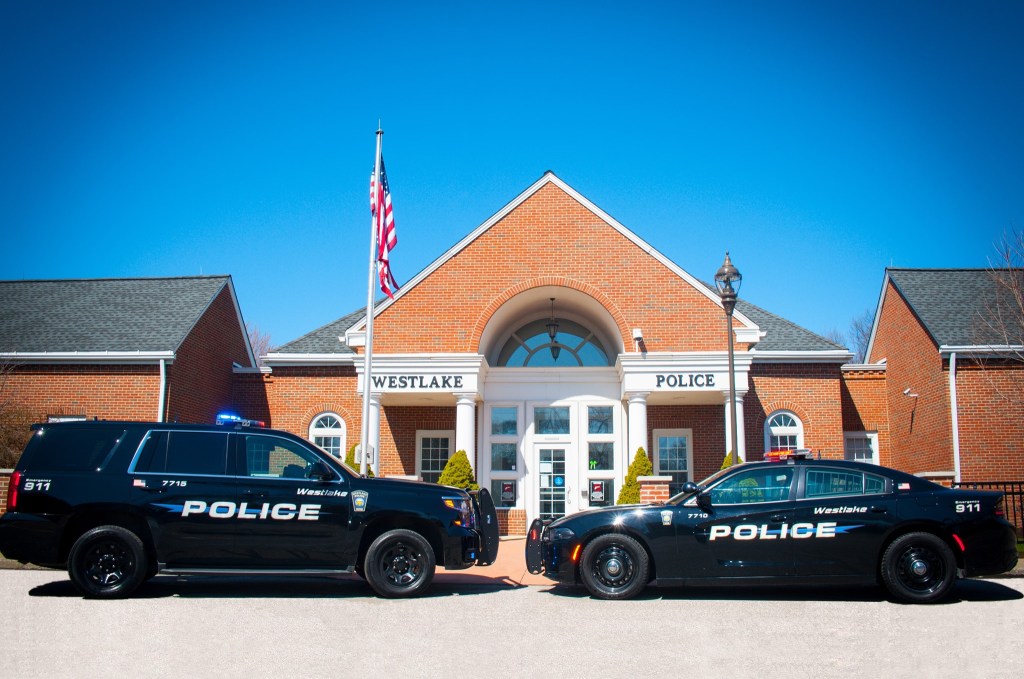 Westlake Police Department with two police vehicles parked in front of the station.