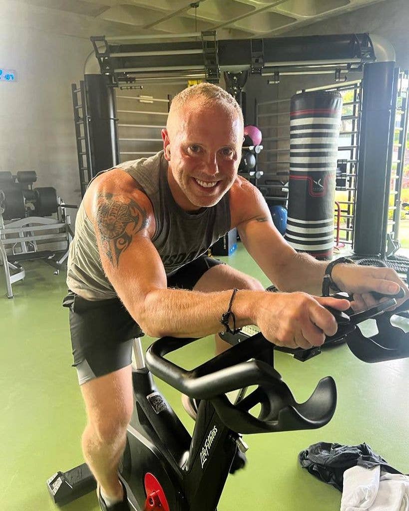 Judge Rinder riding an exercise bike in his gym