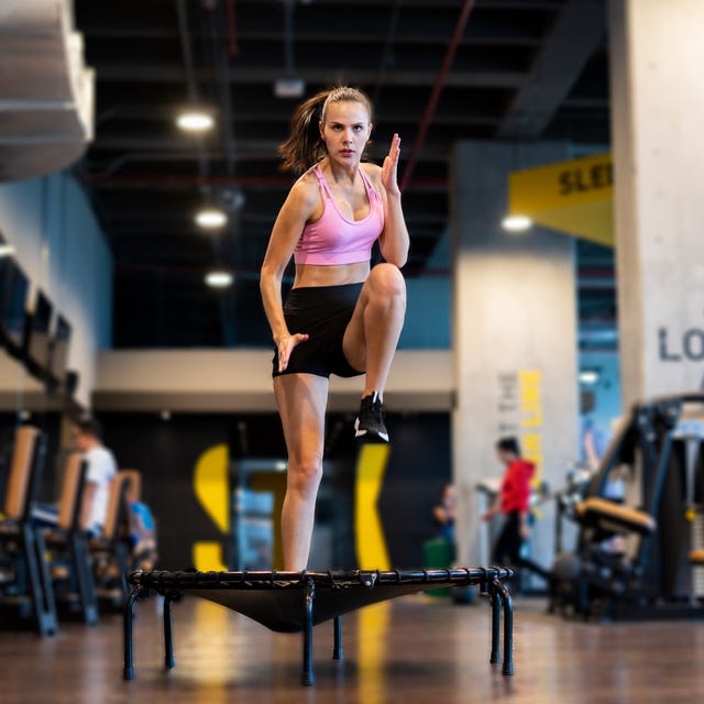 Latin woman at the gym exercising on a trampoline