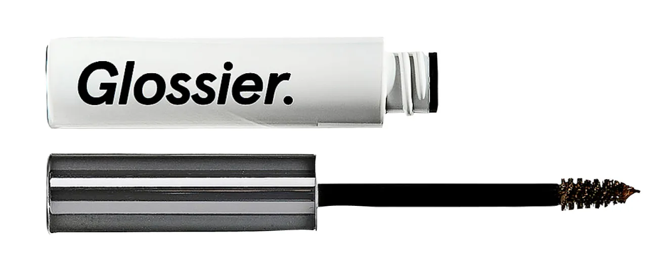 An open tube of Glossier Boy Brow with its wand and brush extended.