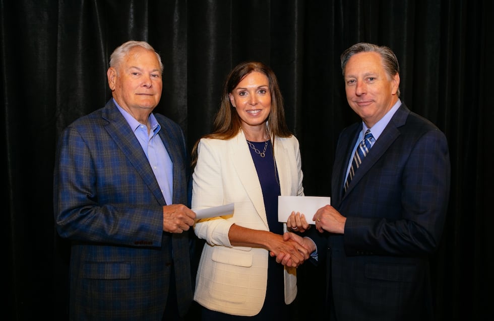 The Dave Russell family and Beth West presented checks to WBU President Dr. Stan Norman.