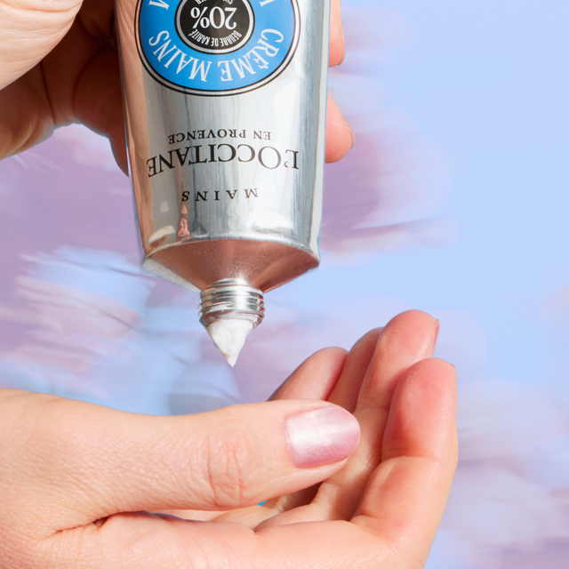 Applying cream from a tube into a hand.