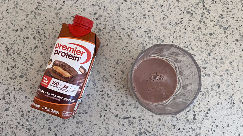 Chocolate Peanut Butter bottle with a glass cup