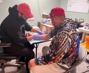 A representative from King County Public Health performs a free TB test at the PICA-WA wellness fair event on March 26 in Federal Way.