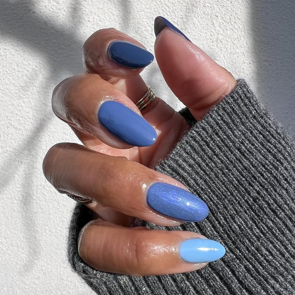 Nails painted in various shades of blue.