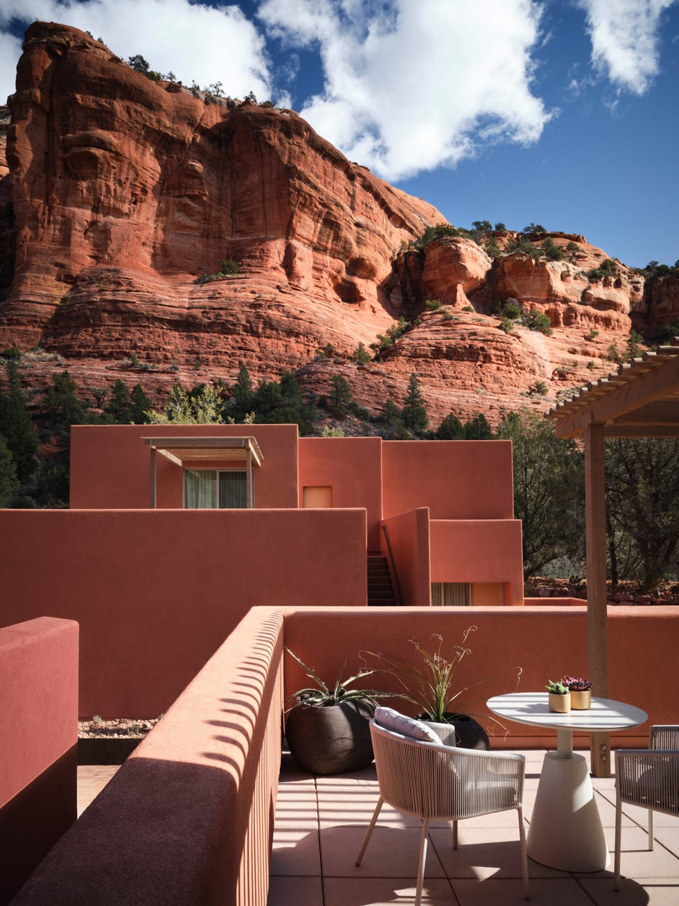 Terrace with modern furniture overlooking red rock formations.
